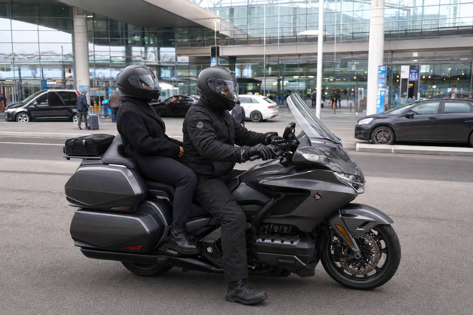 Taxi moto Honda Gold Wing devant un terminal d'aéroport pour les transferts Roissy-CDG et Orly en Île-de-France